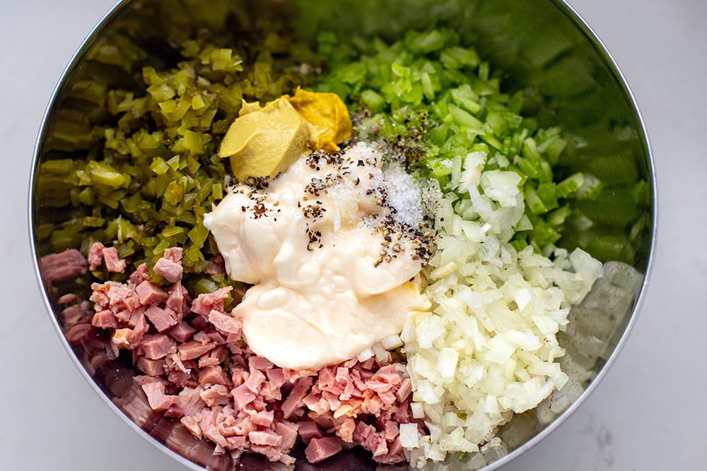 making salad with ham, gherkins, onions, celery and mayo dressing.