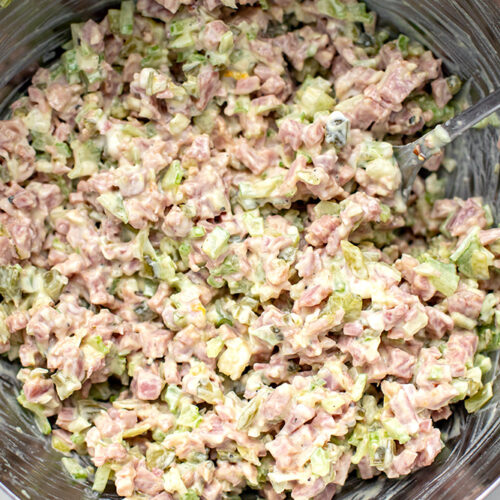 how to make ham salad - mixing everything with the dressing in a bowl.