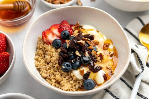 Quinoa breakfast bowl with Greek yogurt, berries, honey and nuts
