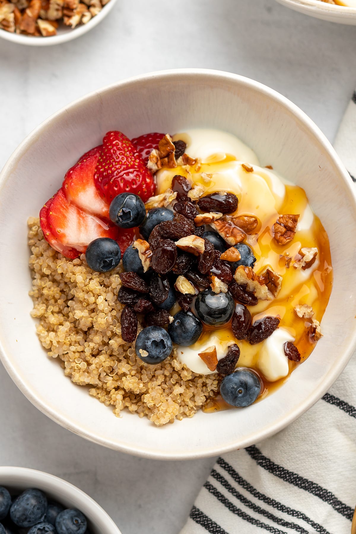 Quinoa breakfast bowl with Greek yogurt, berries, honey and nuts.