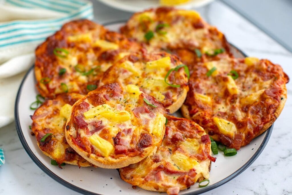 mini pizza with ham and pineapple on English muffins and naan bread