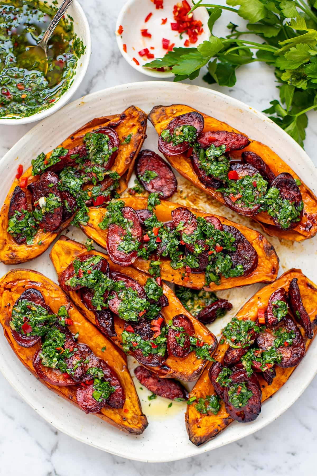 Roasted sweet potato halves with grilled chorizo and chimichurri, inspired by choripan recipe