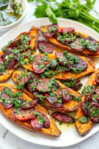 Grilled chorizo with chimichurri sauce over baked sweet potato halves, served with broccolini - paleo, whole30, gluten-free