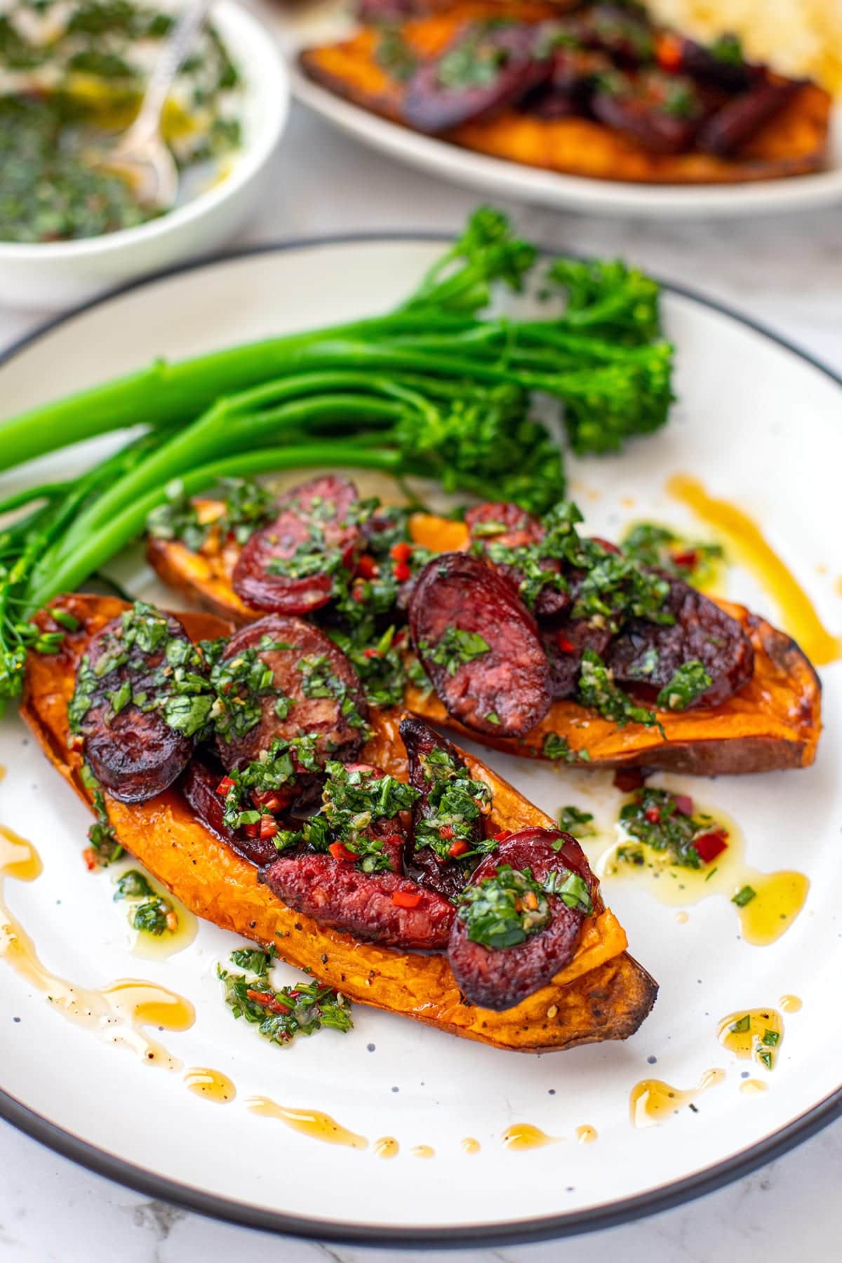 Grilled chorizo with chimichurri sauce over baked sweet potato halves, served with broccolini - paleo, whole30, gluten-free