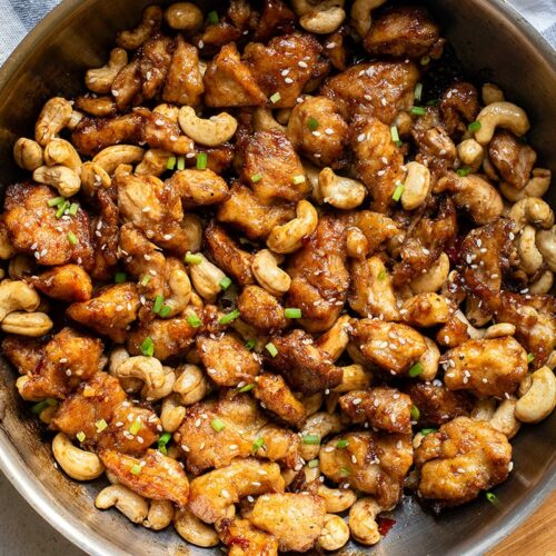 cashew chicken with honey soy sauce in a skillet feature