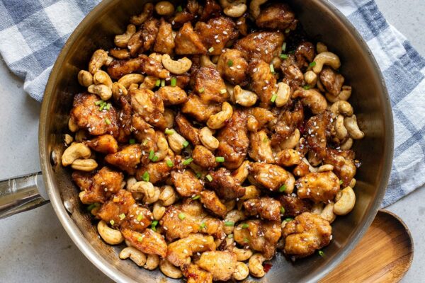 cashew chicken with honey soy sauce in a skillet feature