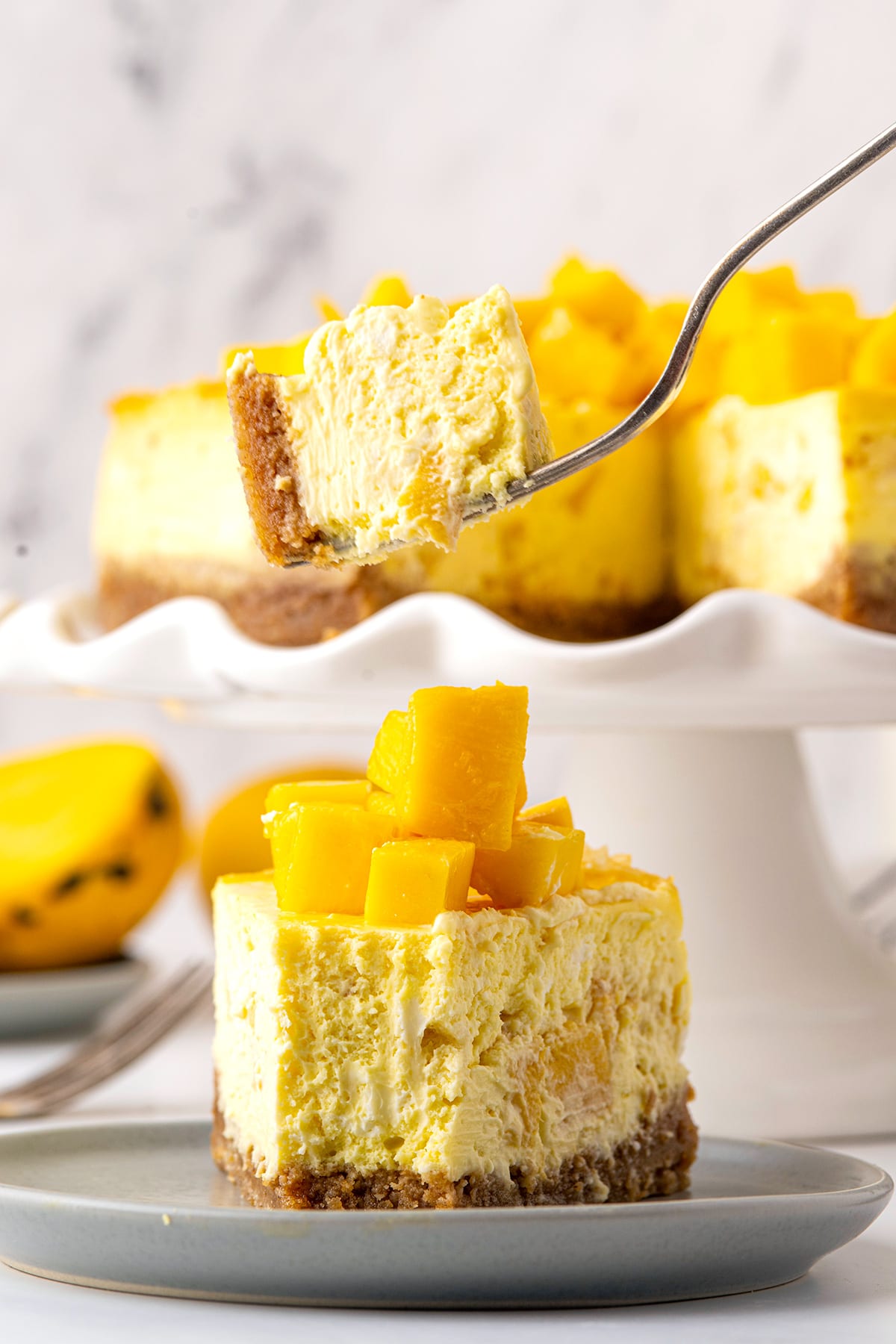Mango cheesecake piece with a fork