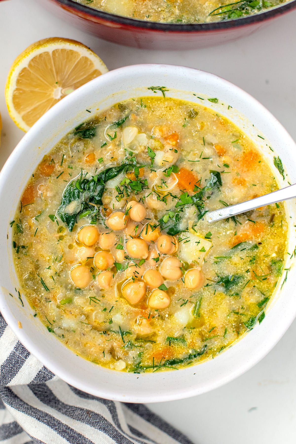 Chickpea soup recipe with potatoes, spinach, parsley, dill and lemon