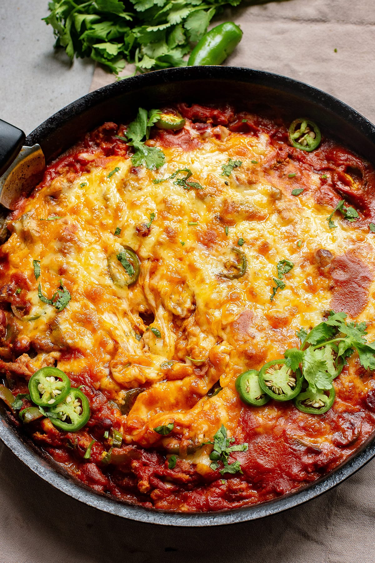 Mexican casserole with ground beef and beans and melted cheese on top