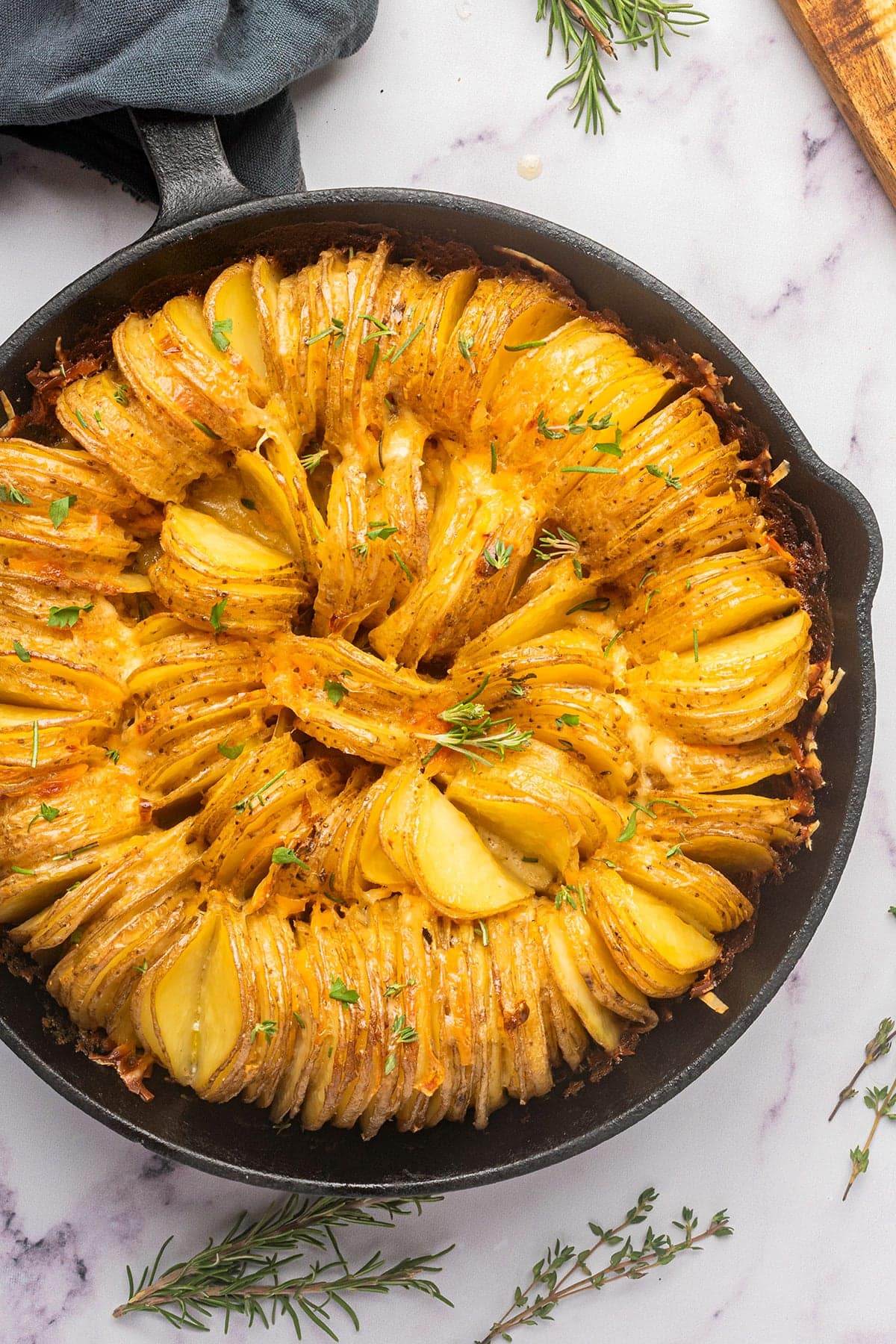 Potato bake in a skillet with melted cheese on top