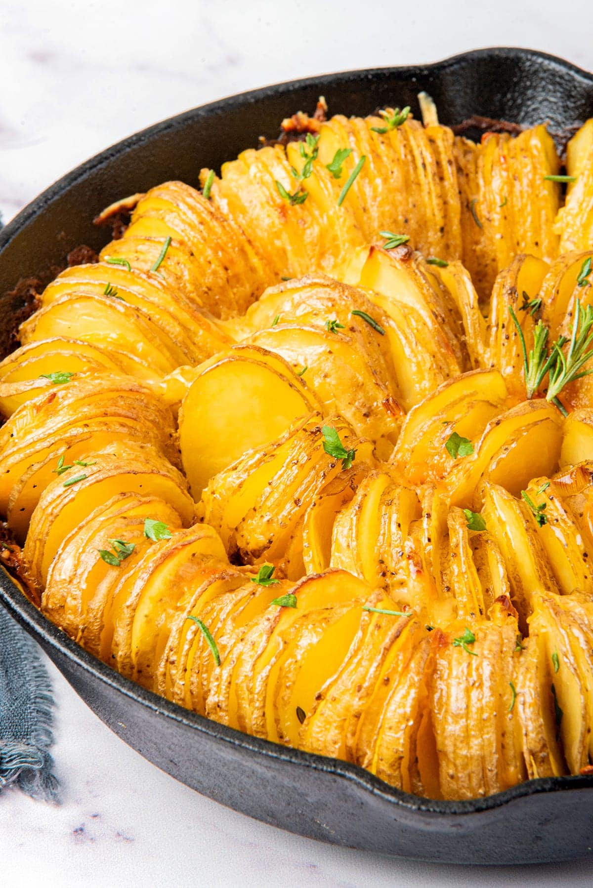 Crispy sliced potato bake in a skillet