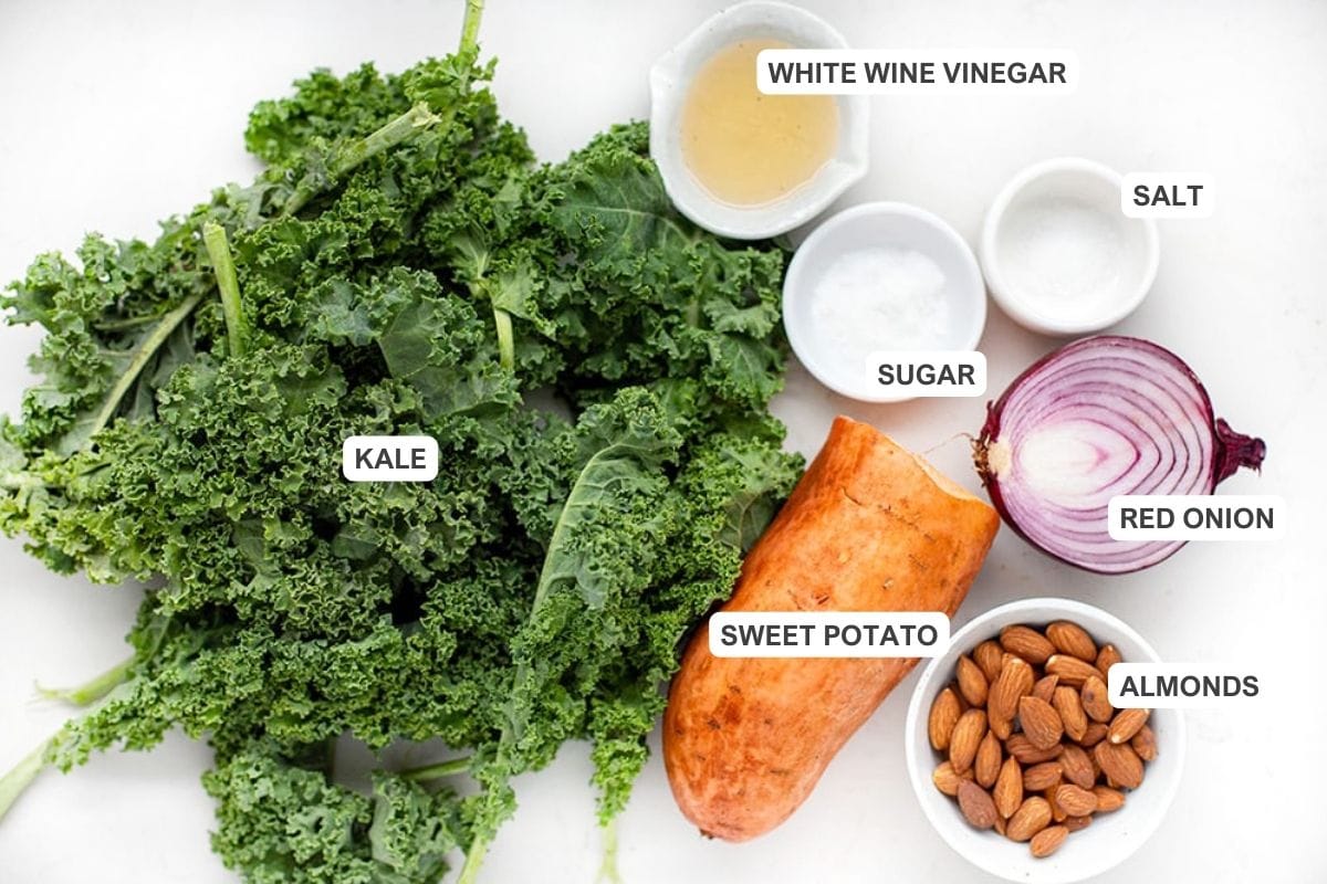Kale salad ingredients: curly kale, sweet potato, almonds, red onion, white wine vinegar, sugar and salt (for pickling onions).