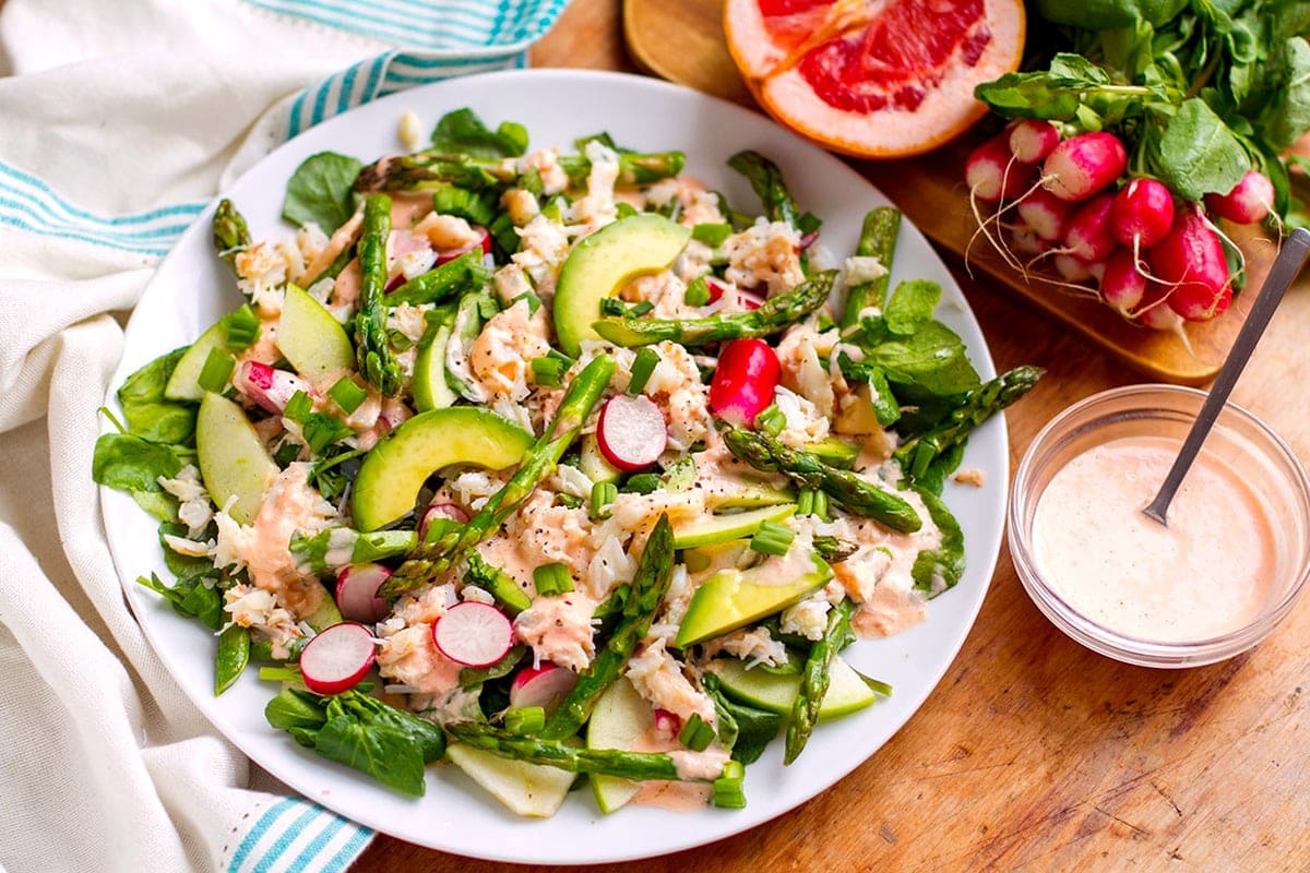 pink grapefruit dressing salad with crab, avocado, and asparagus