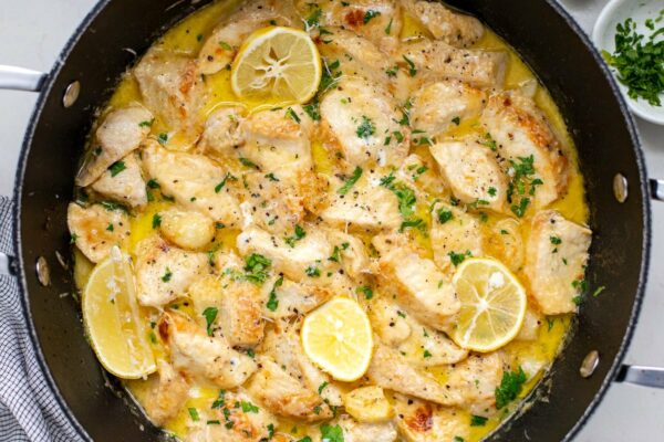 Garlic Parmesan chicken with creamy sauce in a skillet