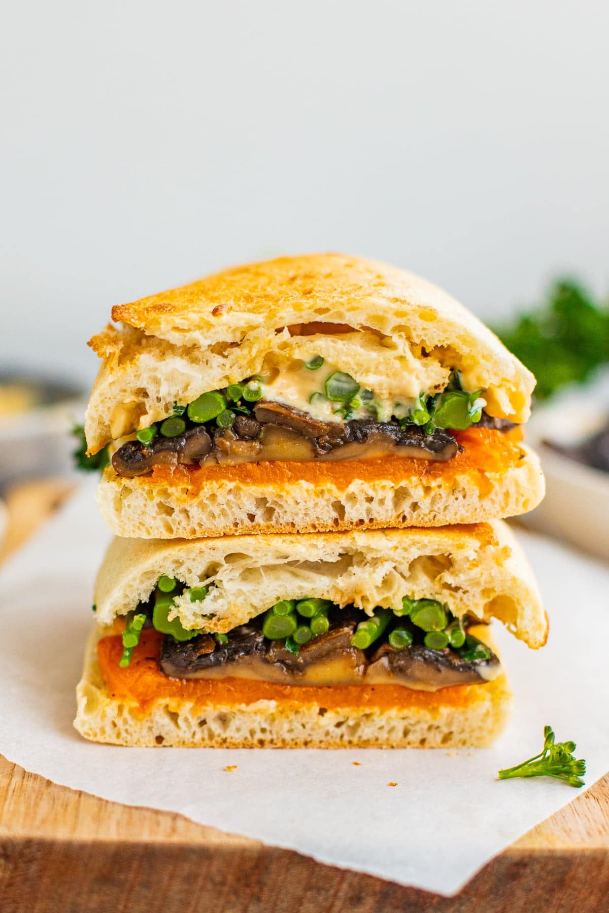 Mushroom sandwich with broccolini and butternut squash halved.