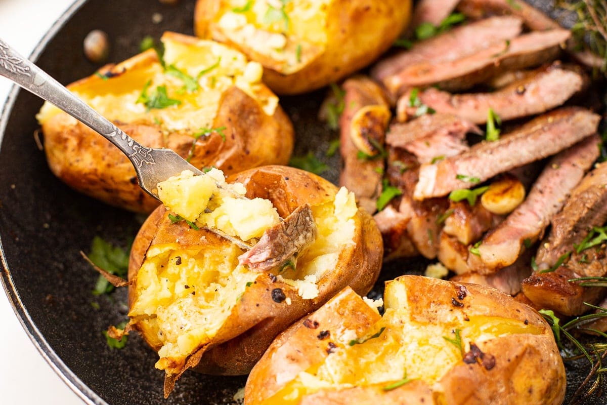 baked potatoes and steak with savoury butter.