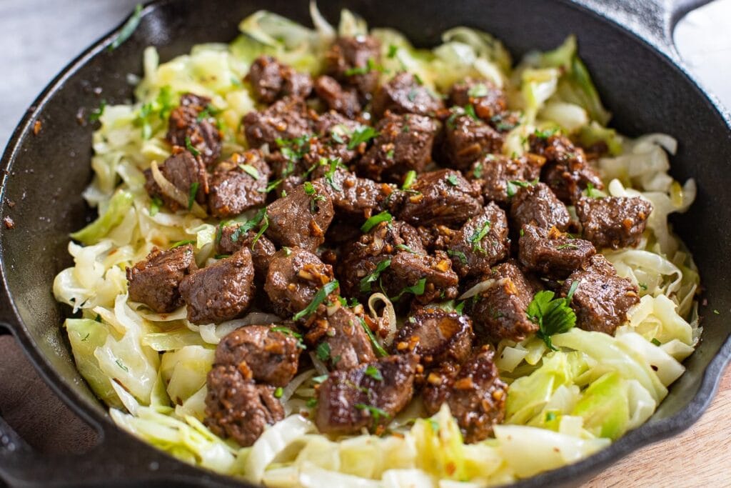 Garlic Butter Steak Bites With Sautรฉed Cabbage feature