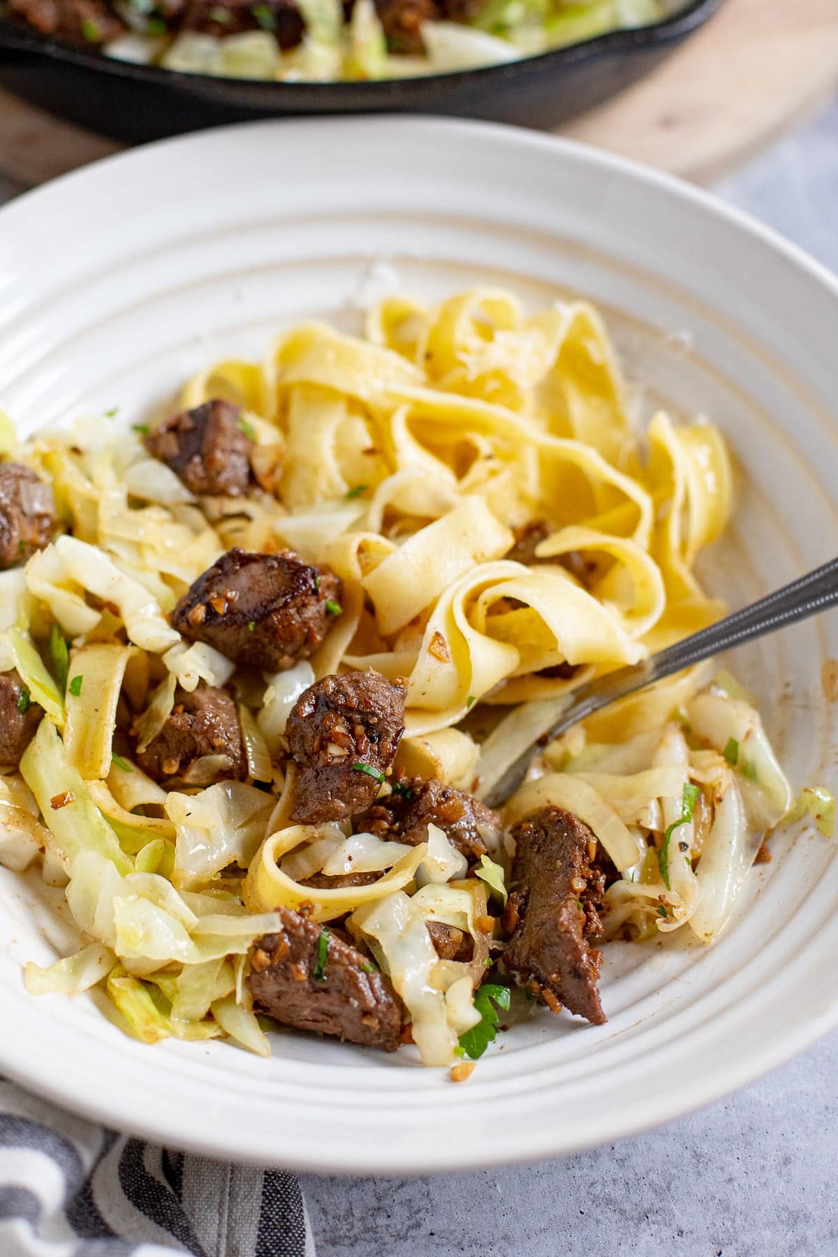Garlic butter steak bites with pasta noodles and cabbage. 