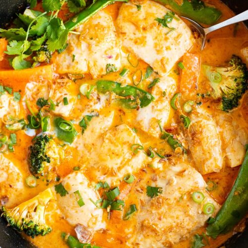 Thai fish curry with snapper in red curry coconut sauce in a skillet