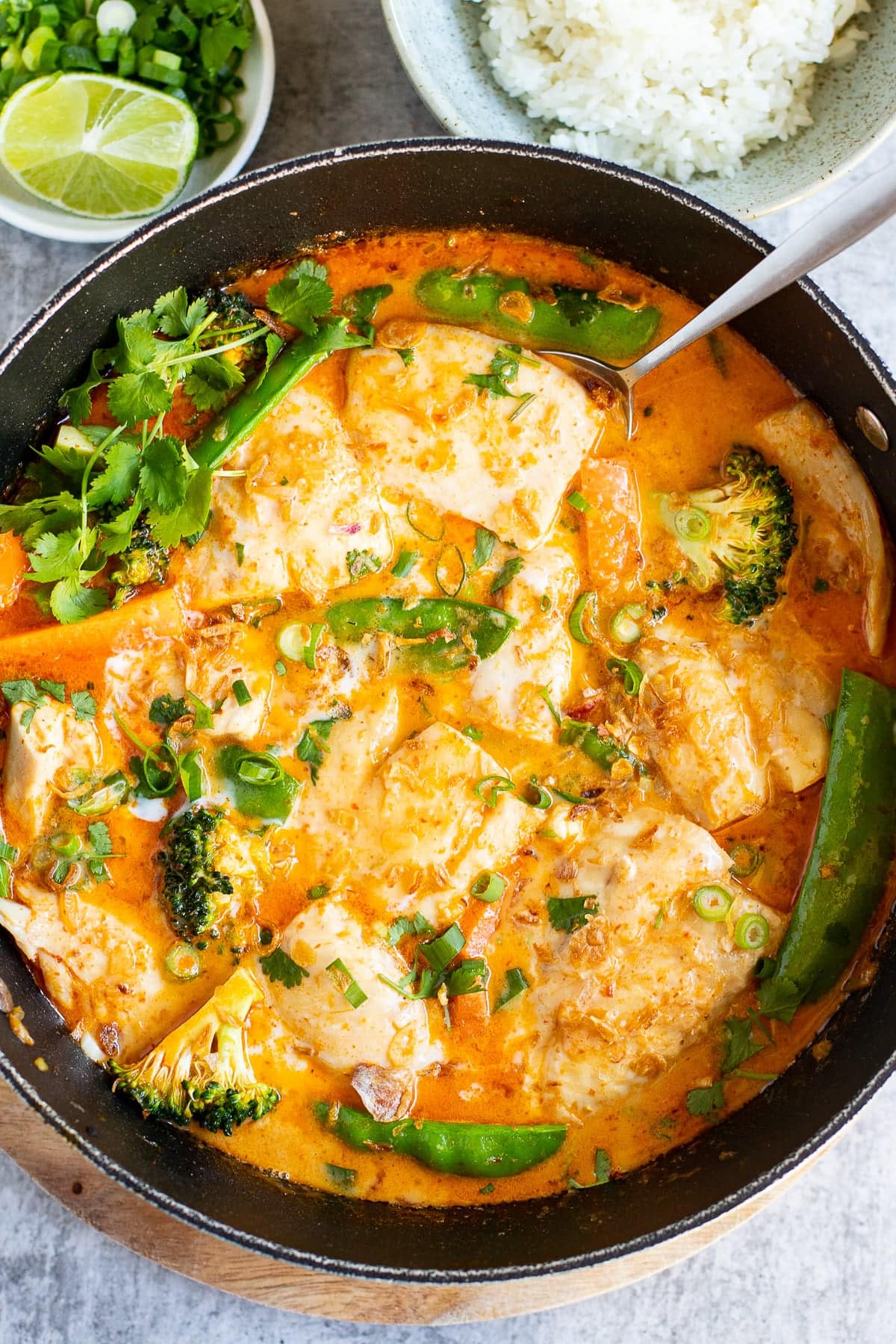 Thai fish curry with snapper in red curry coconut sauce in a skillet