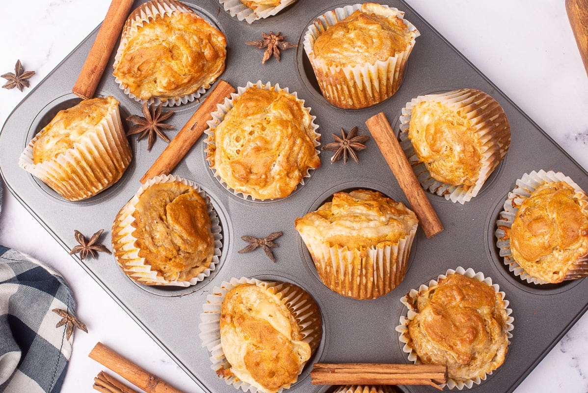 pumpkin muffins with cream cheese in a muffin tray
