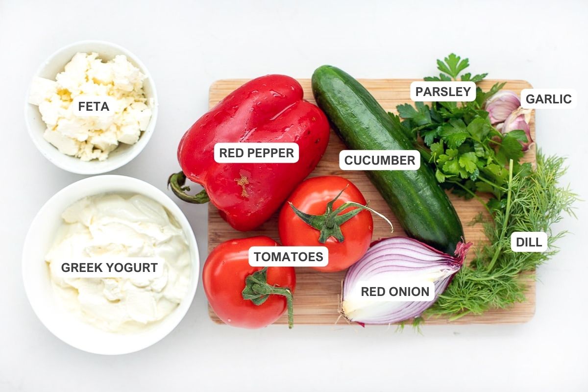 Ingredients for the salad including Lebanese cucumber, tomato, red bell pepper, and onion.