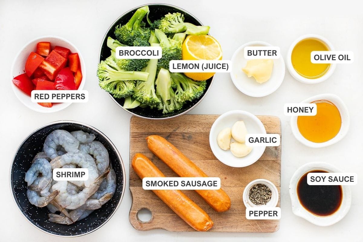 Ingredients for the shrimp and sausage skillet including broccoli. olive oil, red bell pepper, garlic, honey, soy sauce, lemon juice, and pepper.