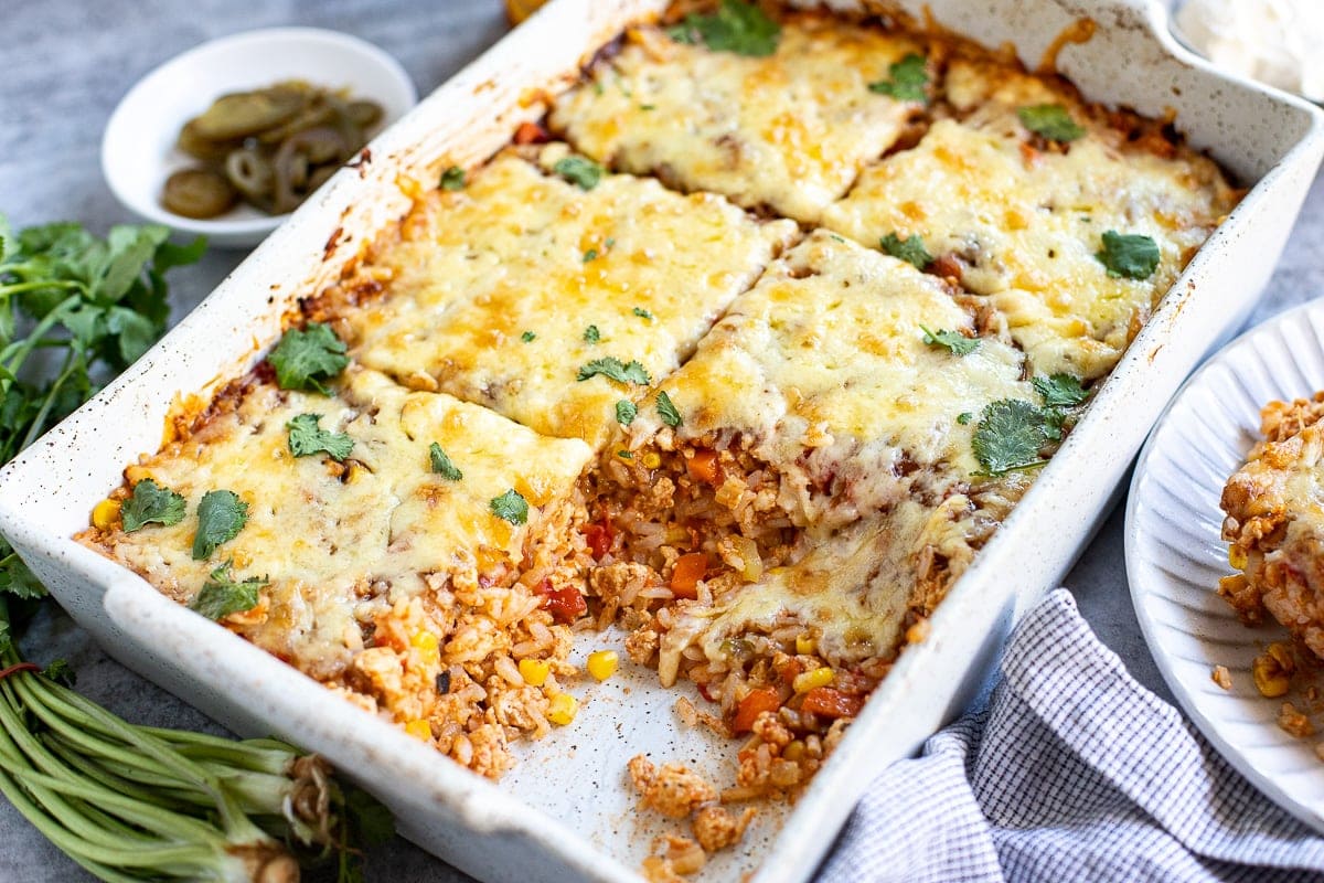 Tex mex casserole with ground chicken, rice, corn, veggies and cheese.