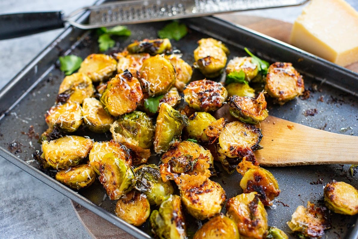 Roasted Brussels sprouts with Parmesan on a baking tray. 
