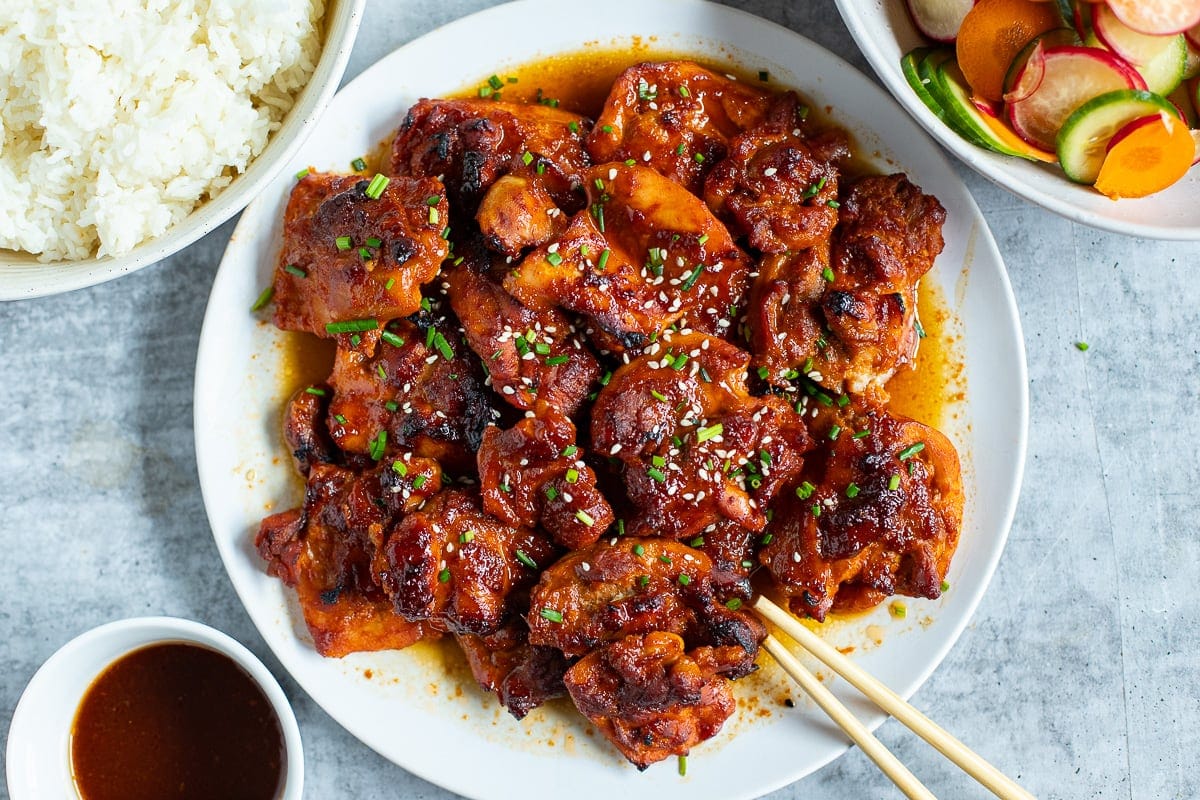Korean Gochujang chicken with rice and pickled vegetables.
