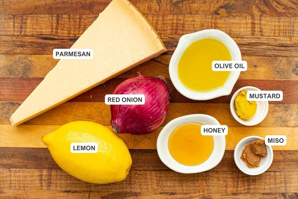 Ingredients for the recipe including lemon, olive oil, honey, mustard, miso paste, and more.