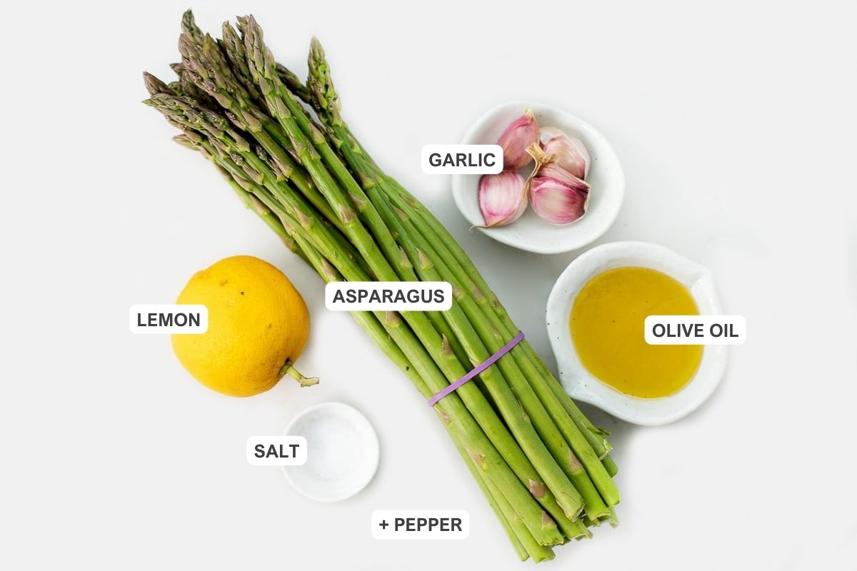 Ingredients for the recipe including asparagus, olive oil, garlic, lemon, and salt.