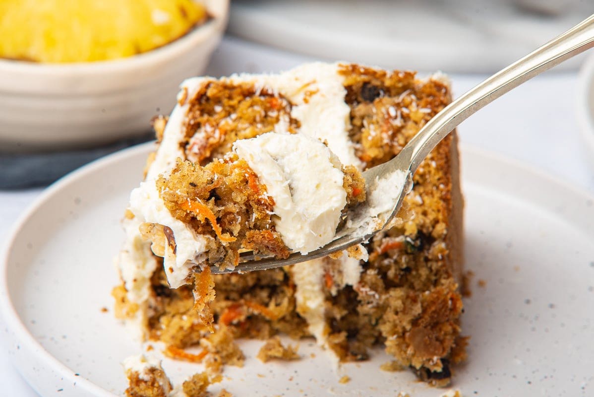 pineapple carrot cake with coconut on a fork