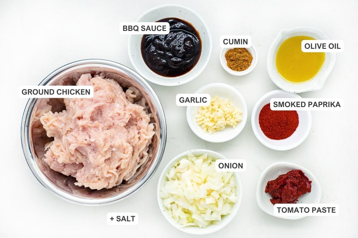 Ingredients for the recipe including ground chicken, salt, BBQ sauce, garlic, onion, cumin, olive oil, smoked paprika, and tomato paste.