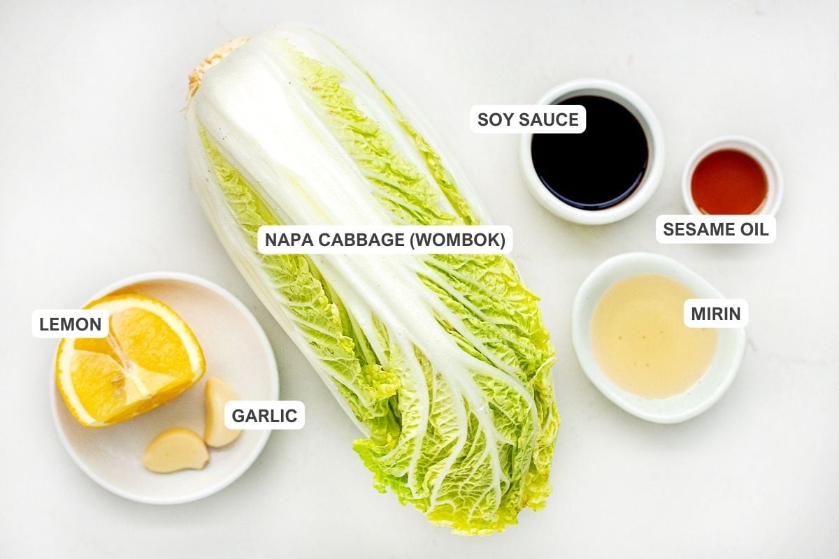 Ingredients for the recipe including napa cabbage or wombok, lemon, garlic, soy sauce, mirin, and sesame oil.