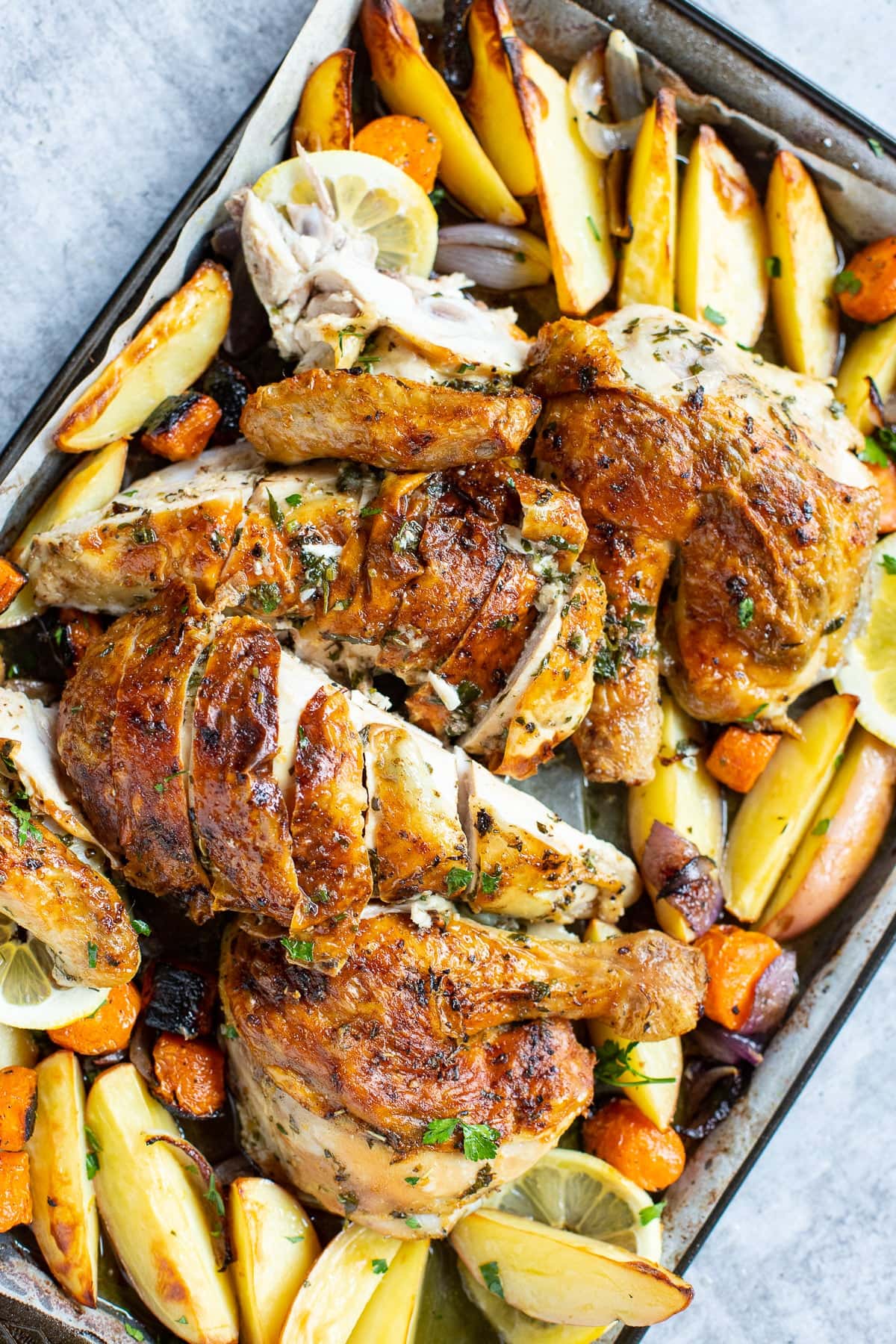 Spatchcock chicken roasted with vegetables.