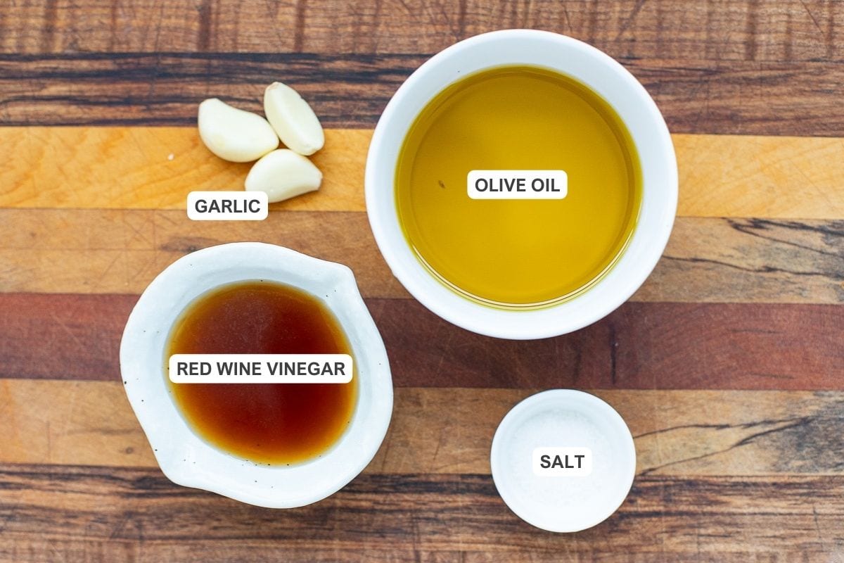 Ingredients for the recipe including garlic, olive oil, red wine vinegar, and salt.