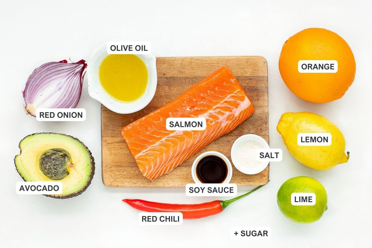 Ingredients for the recipe including salmon, olive oil, soy sauce, salt, orange, lemon, lime, red chili, sugar, red onion, and avocado.