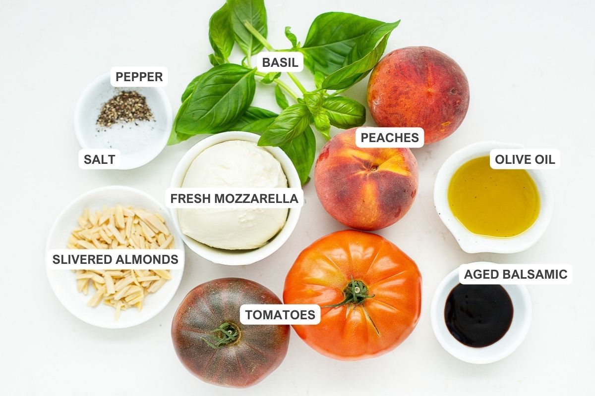 Ingredients for Caprese: peaches, tomatoes, basil, fresh mozzarella, olive oil, aged balsamic, pepper, salt, and almonds.