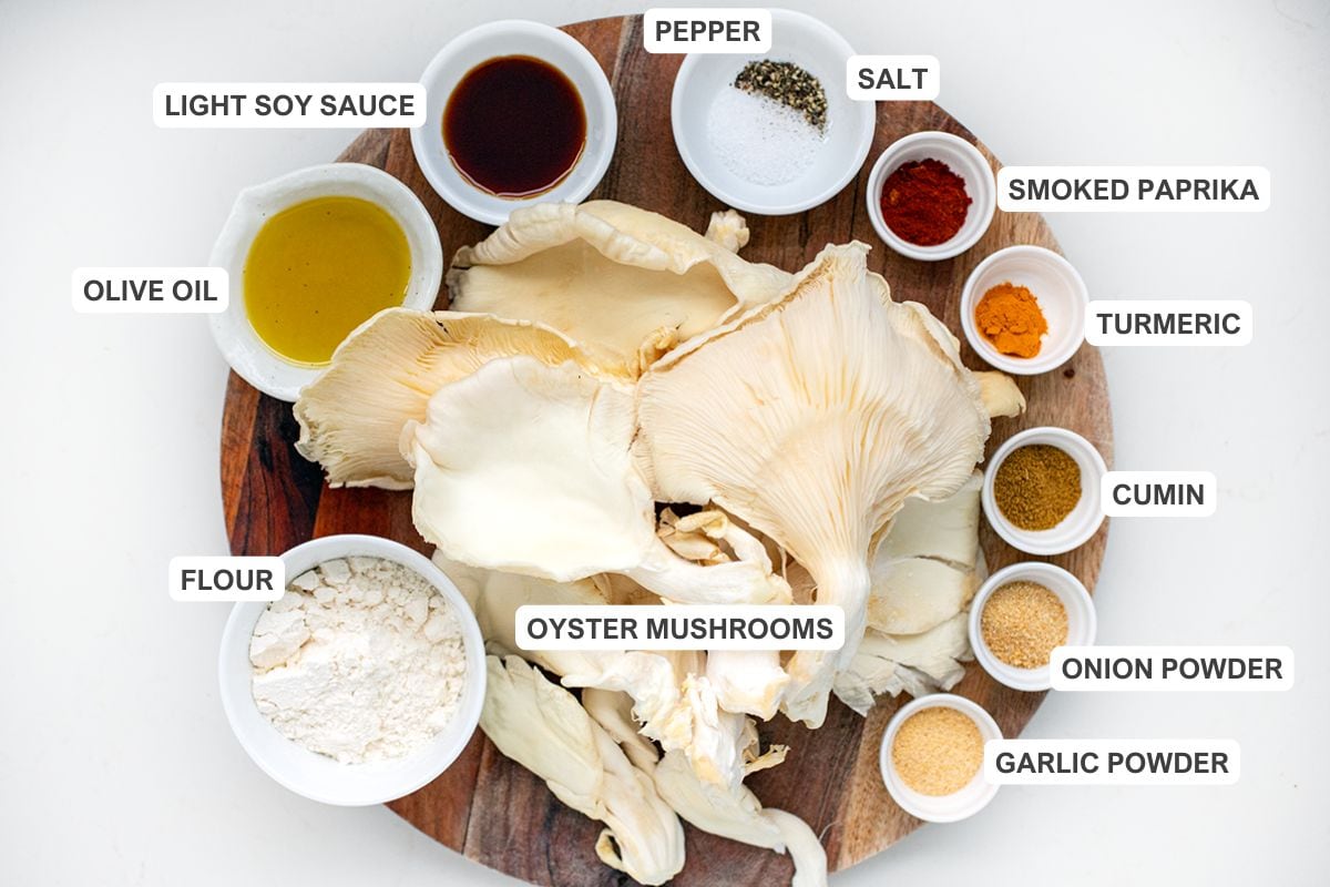Ingredients for the recipe including oyster mushrooms, flour, olive oil, light soy sauce, pepper, salt, smoked paprika, turmeric, cumin, onion powder, and garlic powder.