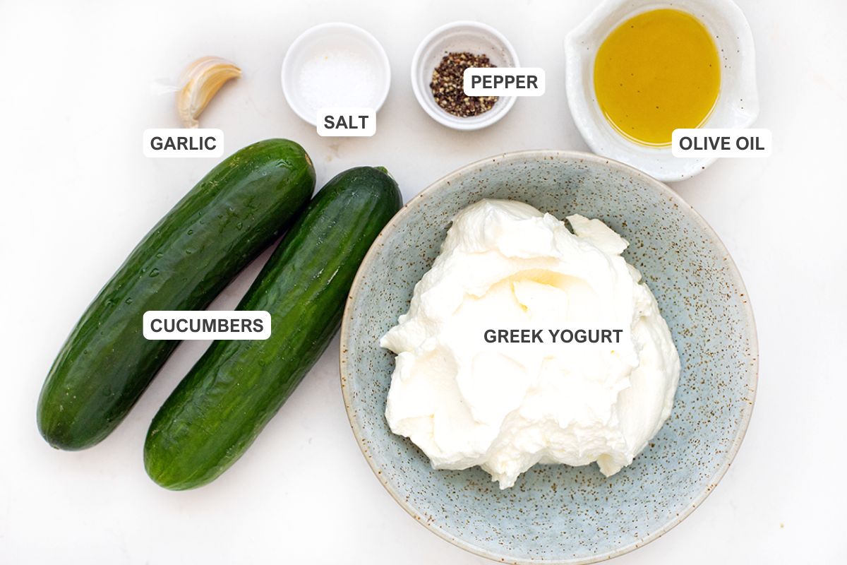Ingredients for the recipe including greek yogurt, cucumbers, olive oil, pepper, salt, and garlic.